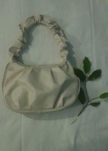 A Beige Side Bag.