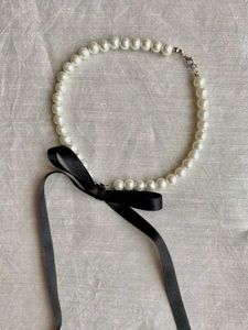 Pearl choker with black ribbon