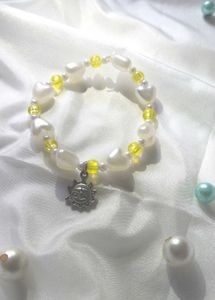 Handcrafted Yellow And White Bracelet With Charm