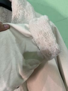 beige jacket with a faux fur collar and cuffs.
