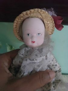 Vintage Porcelain Doll with Straw Hat