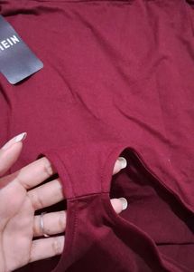 One-Shoulder bodysuit with tag.