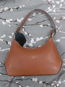 Chic Brown Handbag with Pom-Pom Charm
