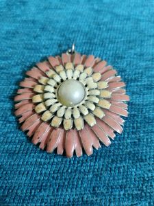 A metal locket - 1.5" in size.