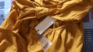 Today&#39;s Offer ₹150 Berrylush Women Solid Yellow Front Twist Knot Fit &amp; Flare Mini Dress For Women (Mustard Colour)