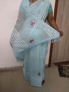 Sky Blue Saree And Blouse  With Red Colour Flower Patches On It With Little Bit Of Stone Work Very Beautiful Saree