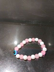 Pink And White Bracelet With An Evil Eye In It