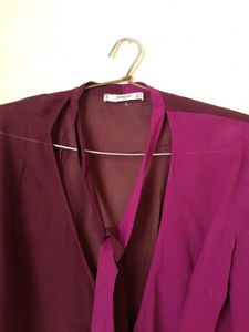 Branded two- tone wrap top.