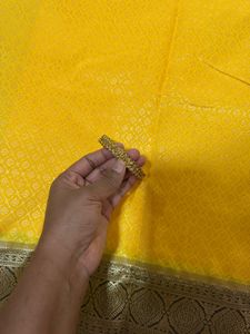 Elegant Yellow Art Silk Saree With A Classy Bangle