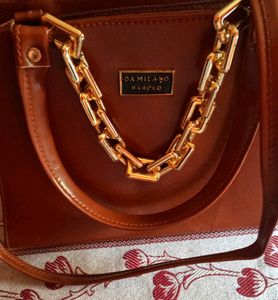 Brown Bag With A Chain Attached To It
