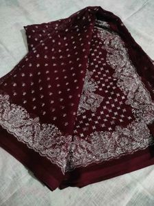 Burgundy saree having white design print.