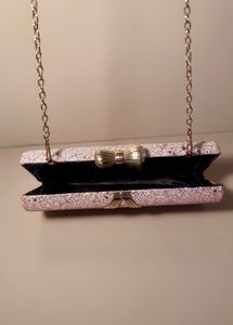 rose‑gold glitter box clutch with bow clasp, chain