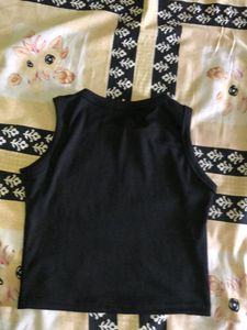 Black no sleeves crop top.
