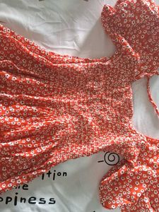 Orange Peplum Top With White Flowers