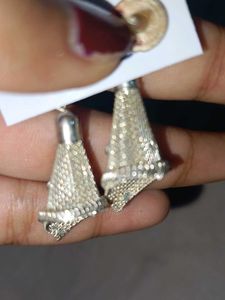 a pair of silver-toned, textured dangle earrings.