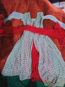 beautiful party wear golden net gown style long kurti with red plazoo and red dupatta