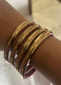 combo of wooden, golden and designer bangles