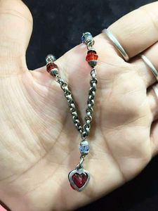 White metal chain with colourful pearls.