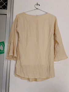This is a Tunic Top With Button On It
