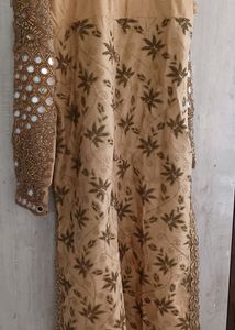 A golden mirror work on jorget suit . with neck work and sleeves fully work completed with salvar and dupatta
