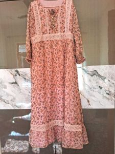 A pink floral gown with white lace trim