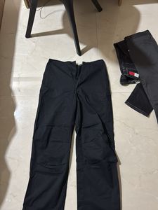 Black trendy parachute pants with adjustable lows