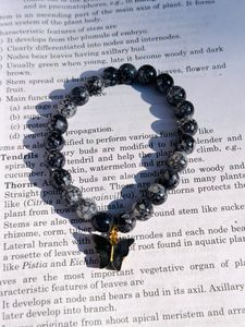 Black Printed Beads Bracelet With Hanging Charm.