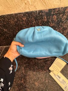 Hidesign sling with leather charm n dust bag