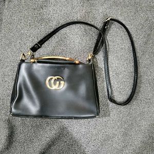Elegant Black Sling Handbag with Gold Detailing