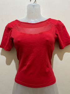top features a V-shaped strap design at the back