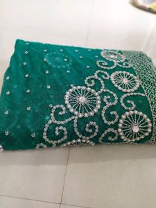 bottle green net saree with blouse and lehnga