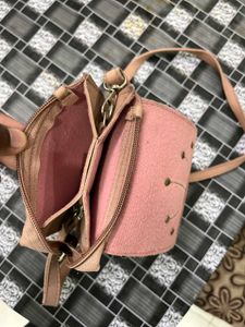 Elegant Pink Sling Bag with Embellished Sunburst