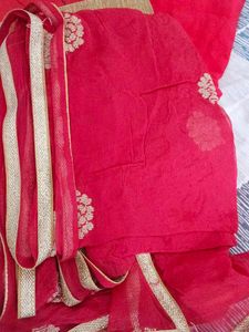 Red stitched women suit with pants and dupatta.