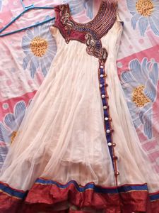 Off white net anarkali with beautiful neckline and beads embroidery. Full length anarkali