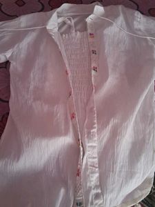 Its A White Top Wear With Multicolor Embroidery