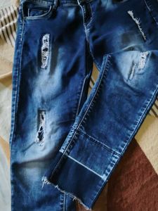 Navy Blue Ripped Jeans With A Design On Bottom