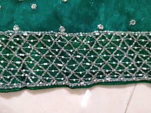 bottle green net saree with blouse and lehnga