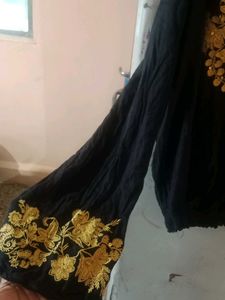 a long sleeves black top with boho vibes and also