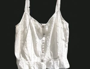 button-up tank top with spaghetti straps.