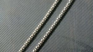 A Black Necklace along With White One