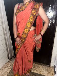 Elegant Orange Saree with Embellished Border