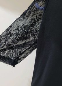 Black Top With Sheer Sleeves And Back Knot