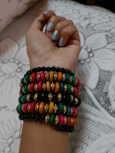 This is a colorful boho-style beaded bracelet stac