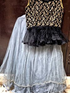 black paplum blouse and grey skirt