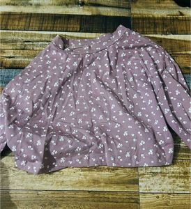 light pink long-sleeved top with a white floral