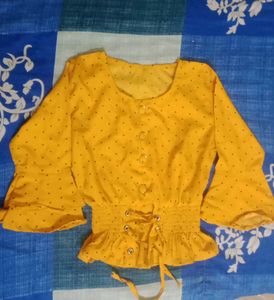 A Mustard Yellow Cinched Waist Top .