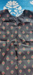 pure cotton black colour long kurta which has red and green printed flowers ..the kurta is unused