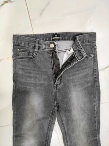 A lightly washed charcoal grey boot cut jeans