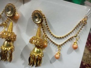 Gold toned Jhumka Earrings with Hair Chain