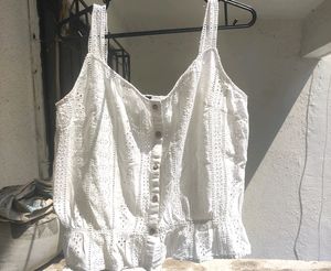 button-up tank top with spaghetti straps.